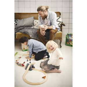 kids playing with railway starter set on the floor