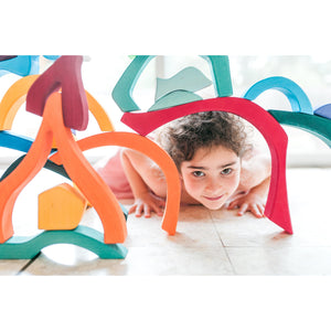girl peaks her face through a structure built with the large four elements building set