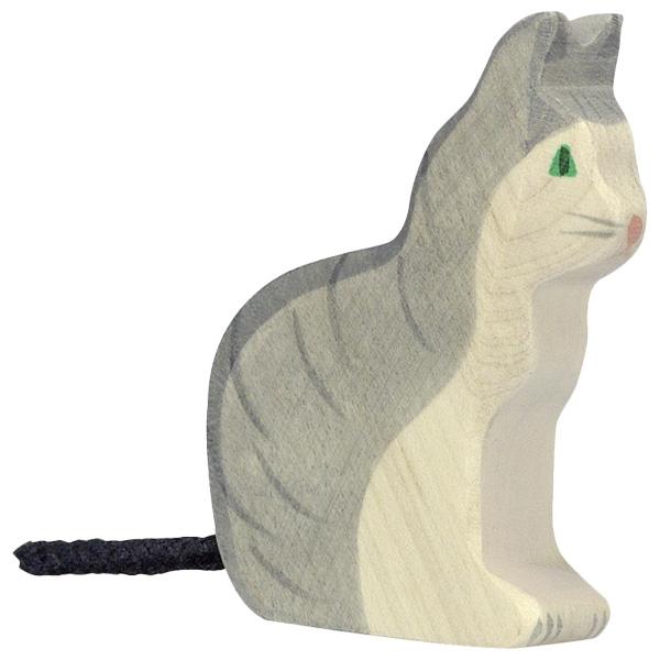 A wooden figure cat with grey paint used as the fur on the beack. Dark grey paint used for detailing. The cats face and belly are white/natural. It has green eyes