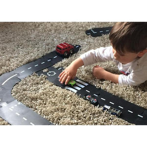 Image of a child playing with the track on carpet.