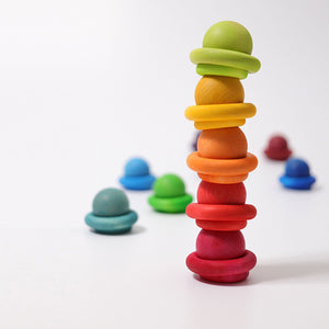 rainbow building rings being used to stack balls vertically