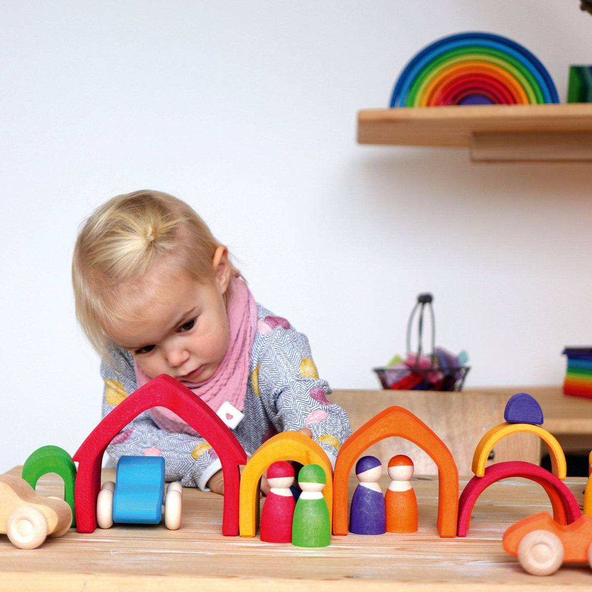 child playing with colorful house blocks