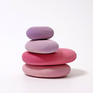 pink tinted wooden pebbles, stacked