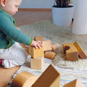 child stacking building blocks