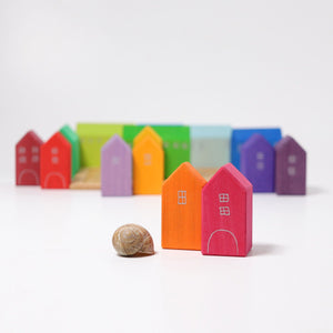 pink and orange houses next to shell, all other houses sitting in the back