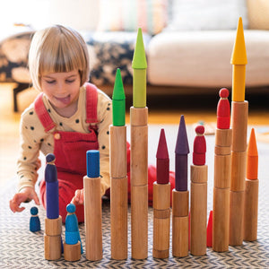 child building with natural rollers, rainbow rollers, rainbow friends, and rainbow forest