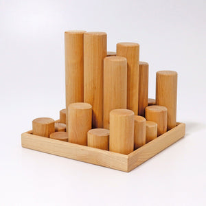 large natural building rollers in frame; rollers are standing vertically