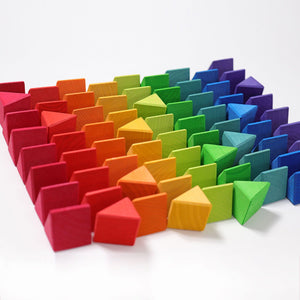 the triangular pieces are laid out in color-coordinated lines. Colors include red, orange-red, orange, yellow, lime green, green, teal, blue, and purple. 