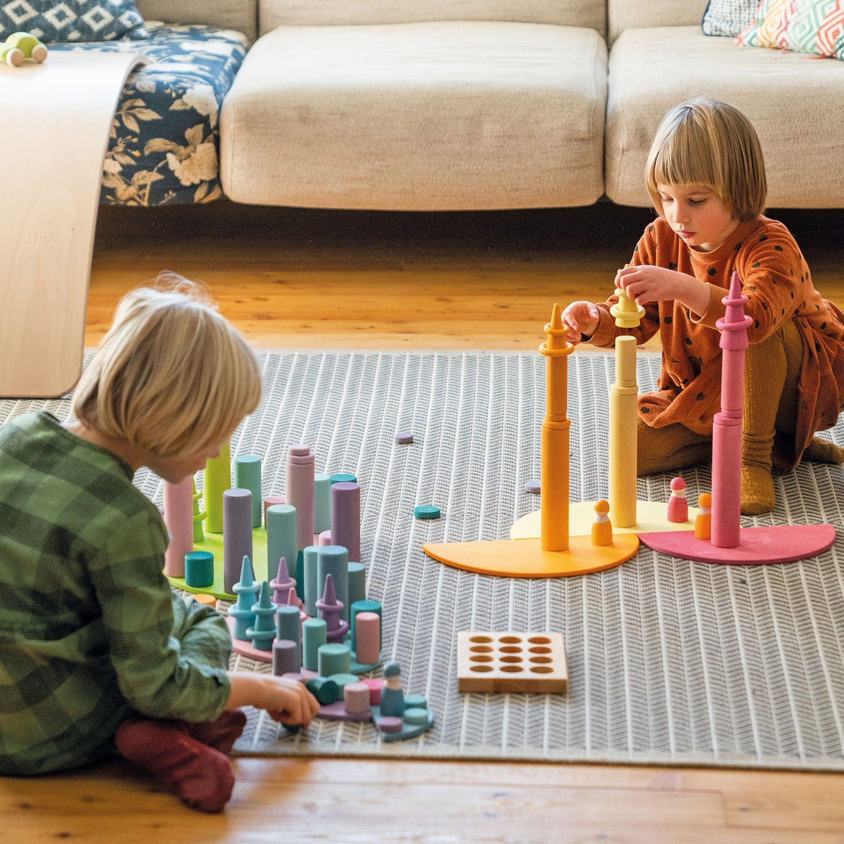 children playing with large pastel semicircles
