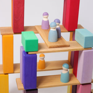 natural building boards with peg figures standing on them