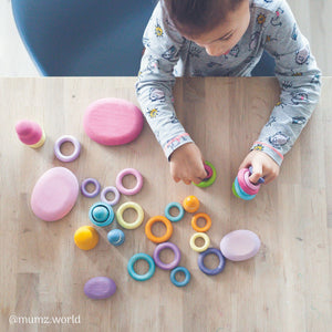boy playing with pastel building rings