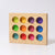 The rainbow sorting board is made from one solid piece of wood with 12 holes removed. Each hole is painted a rainbow color that matched the rainbow friends and small rainbow balls. Colors include: lime green, green, teal, yellow, orange, bright red, dark red, maroon, dark purple, bright purple, royal blue, and baby blue.