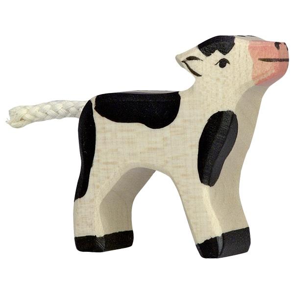 A calf wooden figure painted white with black spots, black hooves, and a pink nose.