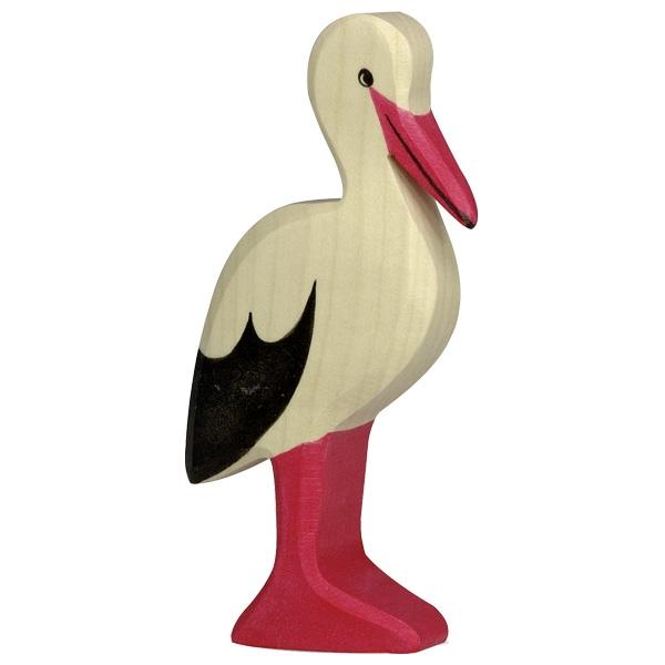 A stork wooden figure with a red-orange bill and feet. Its body is white with black wing tips.
