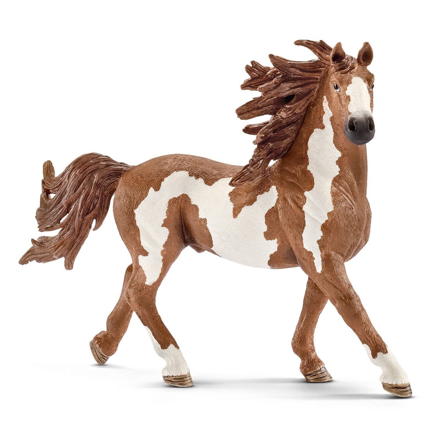 Pinto Stallion plastic figure. The stallion is hand painted with white and brown spots, true to what the pinto stallion looks like. It is built to look like it is running, its mane and tail are blowing in the wind.